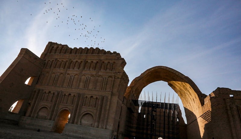 Birds fly over the Arch of Ctesiphon.