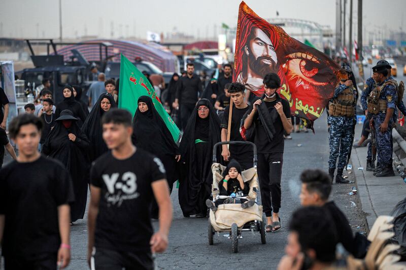 Shiite Muslim pilgrims march from Iraq's capital Baghdad on their way to Karbala on Monday. AFP