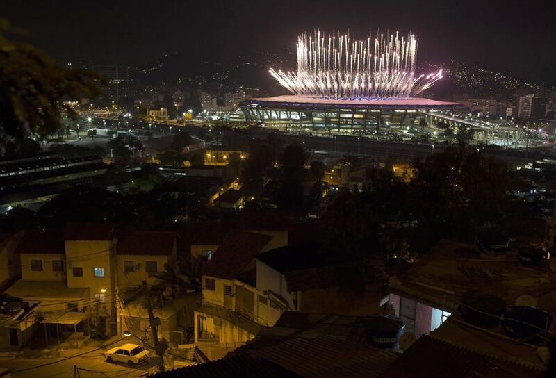 The Mangueira slum is backdropped by fireworks exploding above the Maracana stadium during the opening ceremony of the Rio’s 2016 Summer Olympics in Rio de Janeiro in Rio de Janeiro, Brazil. Leo Correa / AP photo