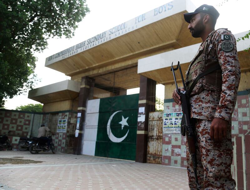 A Pakistani soldier stands guard outside a polling station in Karachi. EPA