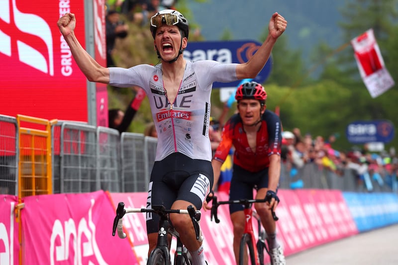 UAE Team Emirates rider Joao Almeida celebrates as he crosses the finish line to win Stage 16 of the Giro d'Italia on May 23, 2023. AFP