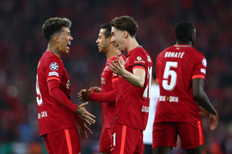 Roberto Firmino celebrates with Kostas Tsimikas after scoring the third goal. Getty