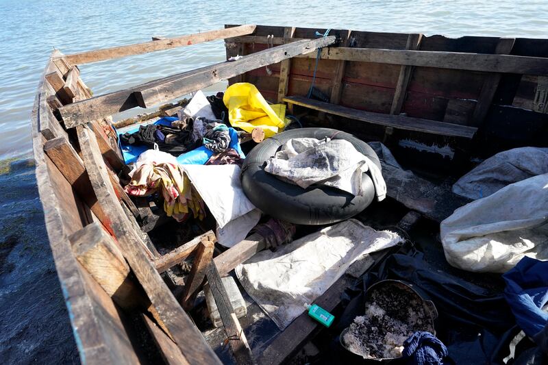 A container with beans and rice, clothes and an inner tube in a recently arrived migrant boat. AP