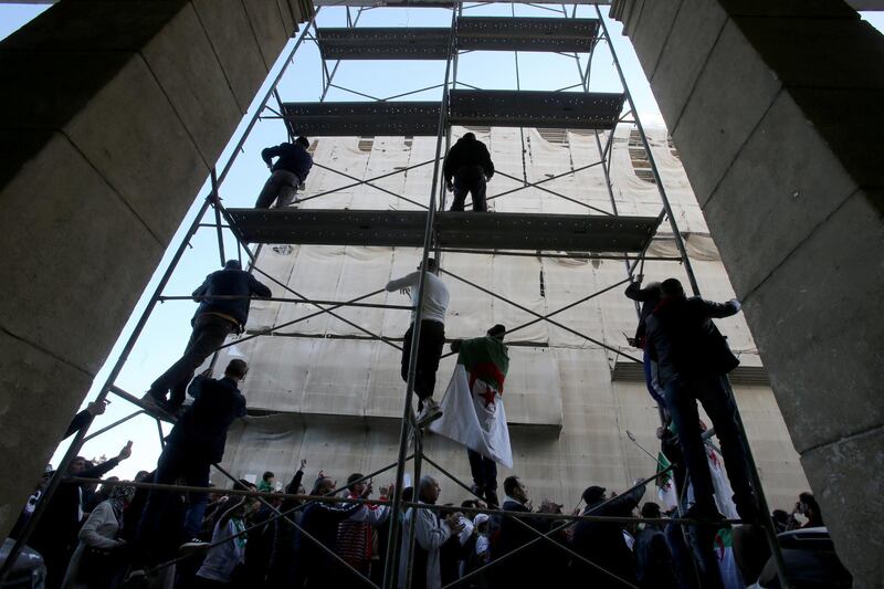 Demonstrators stand on a scaffolding during a protest demanding a change of the power structure in Algiers, Algeria. Reuters