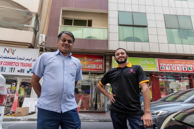 Naseer Muhammed (L), from Kerala in India and Pakistani salesman Atif Mehmood helped to rescue the cat. Antonie Robertson / The National