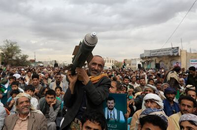 A Houthi supporter carries a mock missile during a rally marking the ninth anniversary of the Saudi military intervention in Yemen's war, in Sanaa, on March 26, 2024. EPA