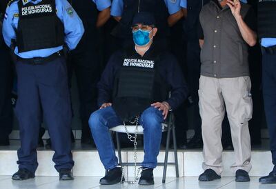 Juan Orlando Hernandez handcuffed at the headquarters of the Honduras Police on February 15, 2022. AFP