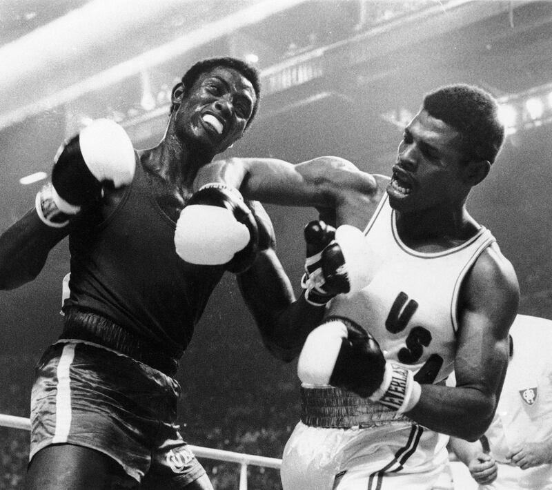 Leon Spinks lets fly with his right at the face of Cuba's Sixto Soria during light heavyweight boxing action at the Olympics in Montreal, July 31, 1976. AP