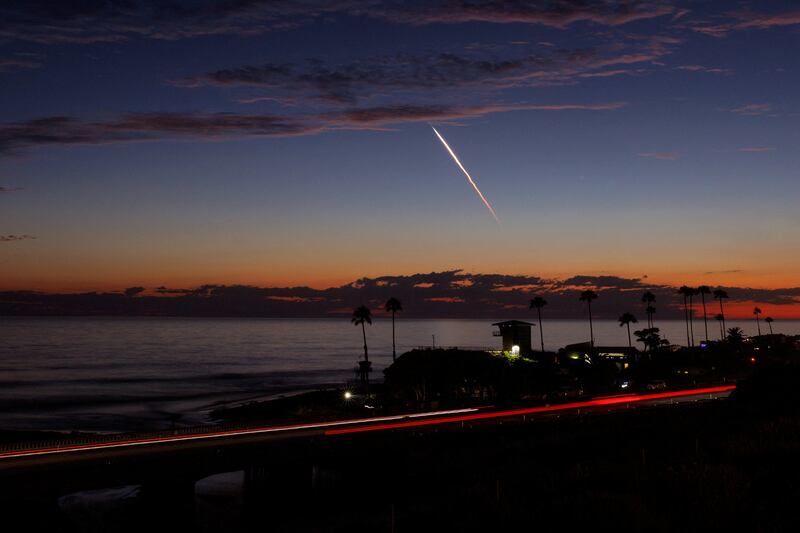 A SpaceX Falcon 9 rocket carrying 20 Starlink satellites streaks across the night sky after launch, as seen from Encinitas, California. Reuters