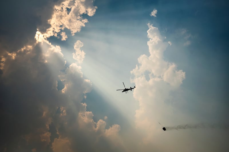A helicopter carries a water bucket while battling the McKinney Fire in Klamath National Forest, in California. AP Photo