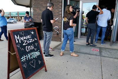 People queue outside Madame Zuzu's in Highland Park, Illinois, for a live-streamed benefit concert hosted by Billy Corgan. AP