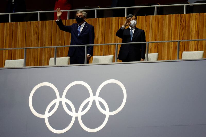 President of the International Olympic Committee Thomas Bach and Japan's Emperor Naruhito wave during the opening ceremony of the Tokyo 2020 Olympic Games.