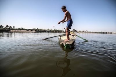 A young Egyptian fisherman pulls his net in the River Nile in Gabal al-Tear village near Minya city, some 265 km south of the Egyptian capital Cairo, on November 13, 2019. - Egypt has for years been suffering from a severe water crisis that is largely blamed on population growth. Mounting anxiety has gripped the already-strained farmers as the completion of Ethiopia's gigantic dam on the Blue Nile, a key tributary of the Nile, draws nearer. Egypt views the hydro-electric barrage as an existential threat that could severely reduce its water supply. But Ethiopia insists that Egypt's water share will not be affected. (Photo by Khaled DESOUKI / AFP)