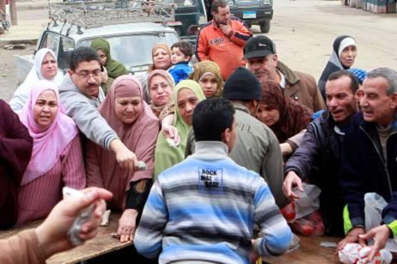 Women queue to buy subsidized food packages at a makeshift store organized by members of the Muslim Brotherhood, in a popular area of Alexandria, January 20, 2012. The Muslim Brotherhood, which won around 45 percent of seats in the new parliament, said its priority in parliament will be improving services in areas such as health, education and transportation to Egypt's population where over 40 percent live on less than $2 a day. REUTERS/Asmaa Waguih (EGYPT - Tags: POLITICS SOCIETY) *** Local Caption ***  CAI108_EGYPT-_0120_11.JPG