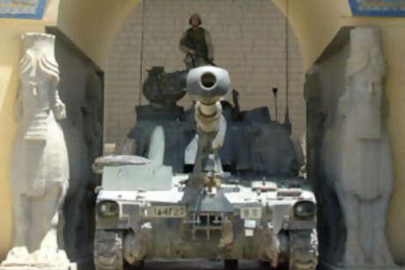 An American soldier stands on a Bradley tank stationed at the main entrance of the National Museum in Baghdad in June 2003.
