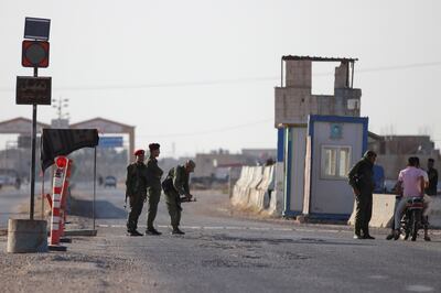 Kurdish guard a checkpoint in Tal Tamer, north-east Syria. Reuters