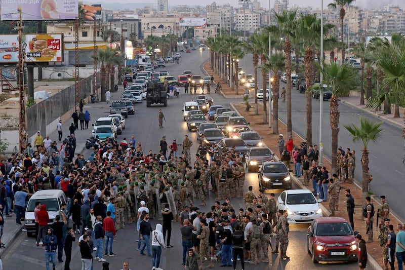 Lebanese army soldiers attempt to reopen a road during ongoing anti-government demonstrations in the southern coastal city of Saida (Sidon). AFP