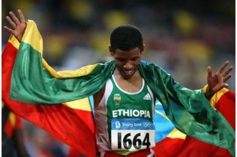 Ethiopia's Haile Gebrselassie celebrates after winning the men's 10,000m at the 2008 Beijing Olympic Games.