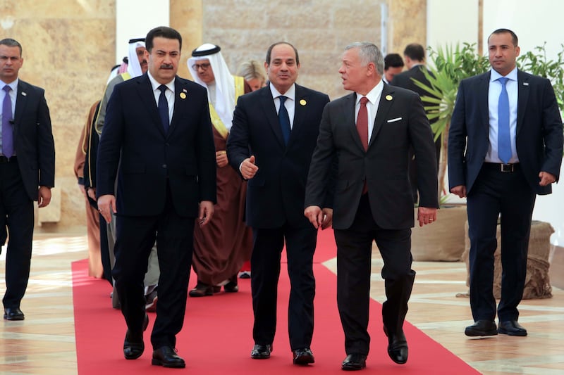Mr Al Sudani, Mr El Sisi and King Abdullah on the red carpet. EPA