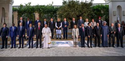 Pope Francis poses with the G7 heads of state and other global leaders in Italy on June 14. Getty