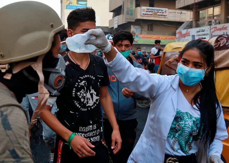 A protester receives first aid during the clashes between Iraqi security forces and anti-government demonstrators, in downtown Baghdad. AP Photo