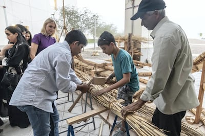 ABU DHABI, UNITED ARAB EMIRATES. 25 APRIL 2019. Boat builders Sajid Valappil and Abdul Salam (LtoR) show a visitor the the event techniques used to manuafacture at  a Bronze Age Boat. An Experimental Archaeological Reconstruction of a Bronze Age Boat at NYU Abu Dhabi (NYUAD). (Photo: Antonie Robertson/The National) Journalist: Daniel Sanderson. Section: National.