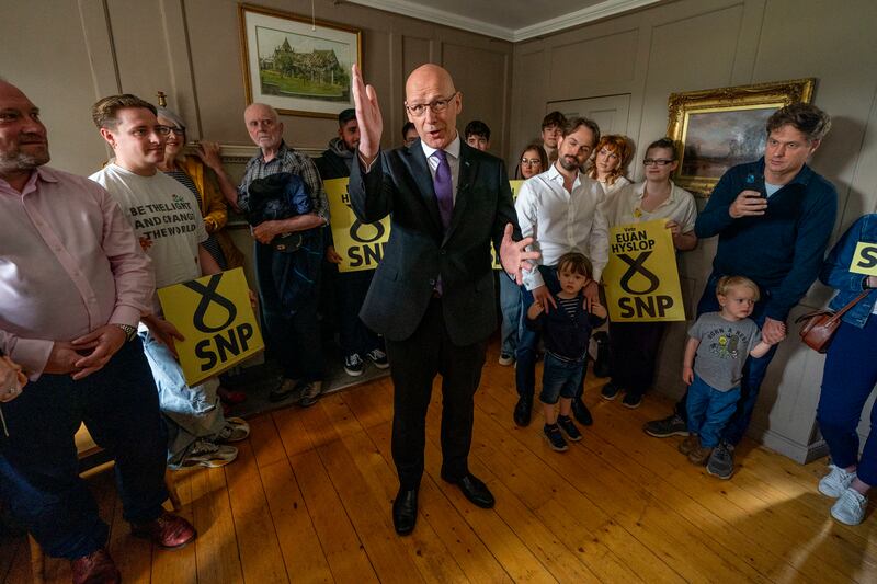 Scottish National Party Leader John Swinney speaks during a visit to The Dower House Cafe in Edinburgh. AP
