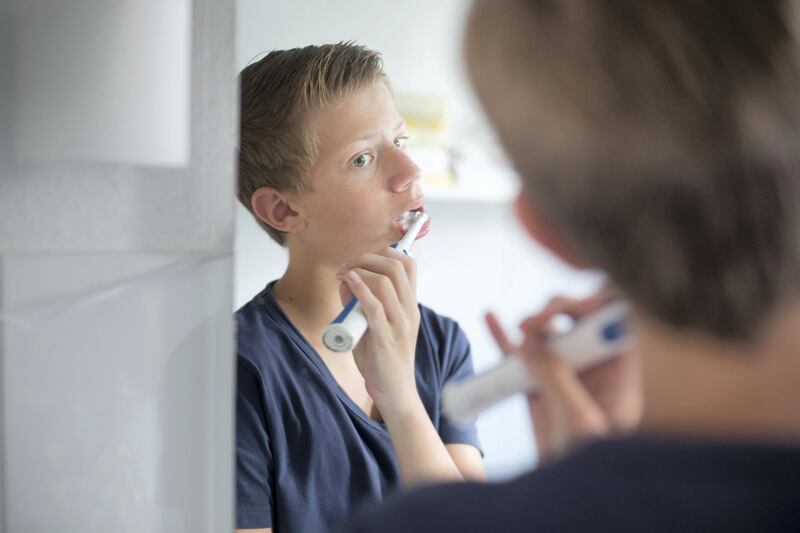 DUELMEN, GERMANY - AUGUST 12: Fourteen-year-old boy brushing his teeth on August 12, 2014, in Duelmen, Germany.  Photo by Ute Grabowsky/Photothek via Getty Images)***Local Caption***