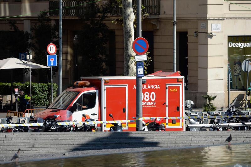 A policeman stands next to an ambulance after a van ploughed into a crowd in Barcelona. Josep Lago / AFP.