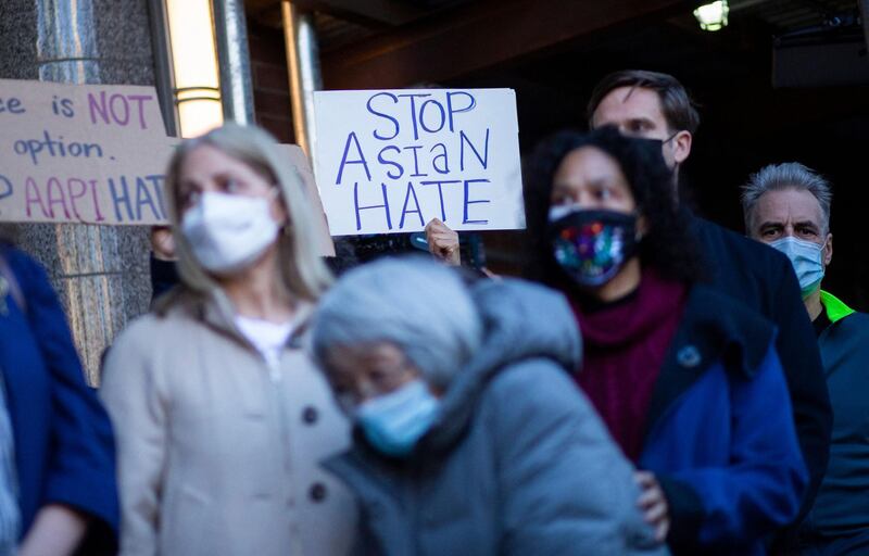 People attend an Asian American anti-violence press conference outside the building were a 65-year-old Asian woman was attacked in New York on March 30, 2021. New York police were searching Tuesday for a man who violently attacked an Asian-American woman as bystanders seemingly looked on without intervening, the latest incident of anti-Asian violence in the United States. The attack, which took place on a sidewalk in broad daylight in Midtown Manhattan on March 29, was caught on CCTV footage from inside an adjacent building. / AFP / Kena Betancur
