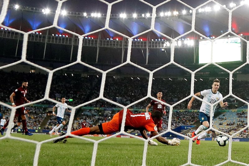 Giovani Lo Celso rounds Venezuela goalkeeper Wuilker Farinez to score Argentina's second goal.  EPA