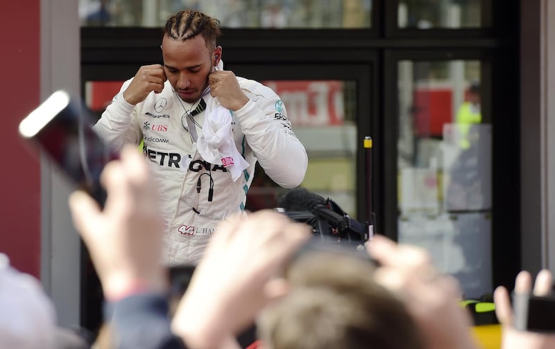 People take images of first placed Mercedes' British driver Lewis Hamilton after winning the Spanish Formula One Grand Prix at the Circuit de Catalunya in Montmelo in the outskirts of Barcelona on May 13, 2018. / AFP / Pierre-Philippe MARCOU
