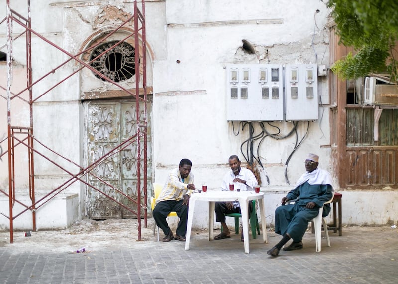 JEDDAH, KINGDOM OF SAUDI ARABIA. 2 OCTOBER 2019. 
Men having some tea in the alleyways of Al Balad, Jeddah’s historical district. The World Heritage Site was founded in the seventh century and was once the beating heart of Jeddah, Saudi Arabia’s second-largest city. The town was formed as an ancient trading port and acted as the primary gateway to Makkah. Today, it is famous for its traditional buildings, which were constructed with coral-stone and decorated with intricate latticed windows.
(Photo: Reem Mohammed/The National)

Reporter:
Section: