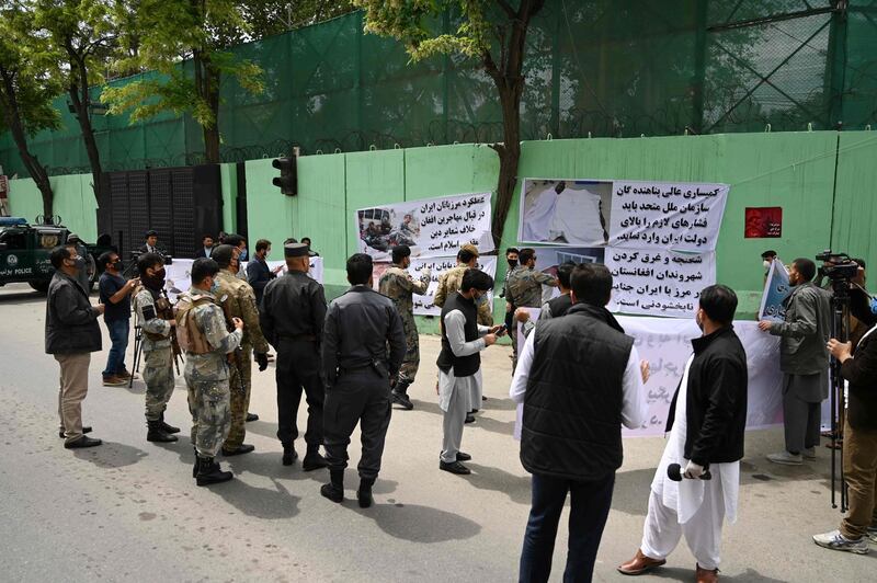 Civil society activists hold banners and shout slogans against the Iranian government during a protest in front of the Iranian embassy in Kabul on May 11, 2020. AFP