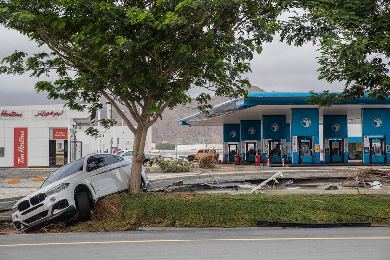 Car swept away in flash floods lies beside a road in Fujairah. Antonie Robertson / The National
