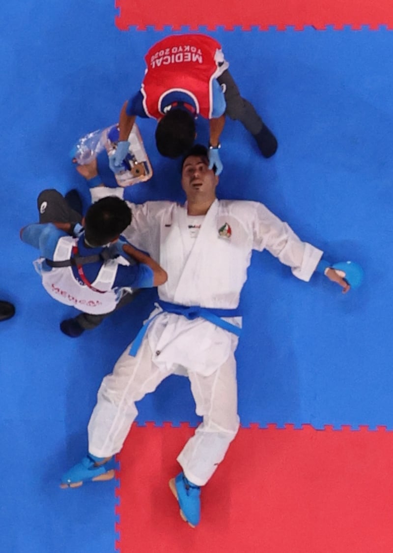 Sajad Ganjzadeh of Iran receives medical attention during his match against Tareg Hamedi of Saudi Arabia.