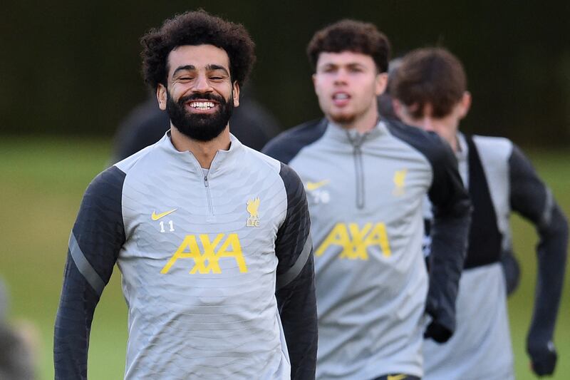 Liverpool's Egyptian midfielder Mohamed Salah (L) laughs during a training session at their training ground in Kirkby, north of Liverpool in northwest England, on December 6, 2021, on the eve of their UEFA Champions League Group B football match against AC Milan.  (Photo by Oli SCARFF  /  AFP)