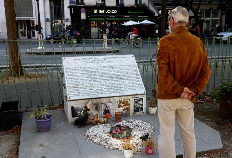 A man looks at the memorial plaque near the Bataclan theatre and cafe in Paris, where extremists killed 90 people on November 13, 2015. AFP