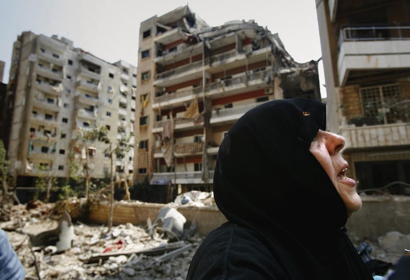 A Lebanese woman outside her destroyed apartment in south Beirut, July 2006. Israeli jets bombed the area late the night before