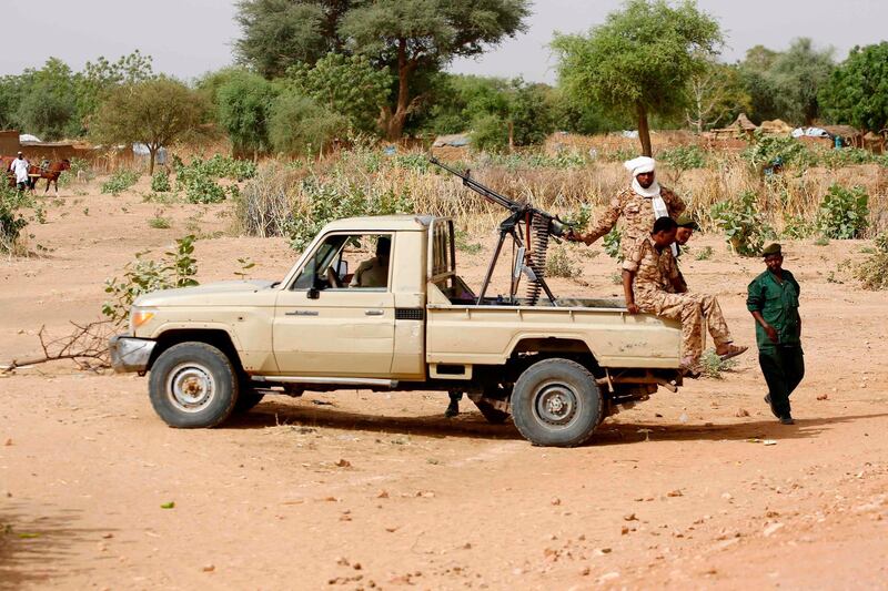 (FILES) In this file photo taken on April 2, 2016, A convoy of Sudanese security forces deploy during a rally in al-Geneina, the capital of the West Darfur state. Ongoing clashes in Sudan's restive Darfur have killed at least 48 people in two days, state media said, just over two weeks after a long-running peacekeeping mission ended operations. The violence has pitted the Massalit tribe against Arab nomads in El Geneina, the capital of West Darfur state, but later morphed into broader fighting involving armed militias in the area. / AFP / ASHRAF SHAZLY
