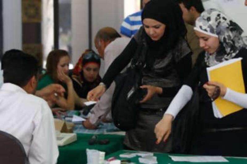 Jordanian youth register for new IDs at a mobile registration centre at Jordan University in Amman. The IDs are necessary to vote in parliamentary elections.