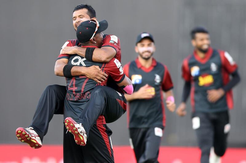 Zohaib Khan celebrating with Dwayne Bravo ( back ) of Lahore Qalandars after taking the wicket of JM Vince of Karachi Kings in the Pakistan Super League T20 match at Sharjah Cricket Stadium in Sharjah. ( Pawan Singh / The National )