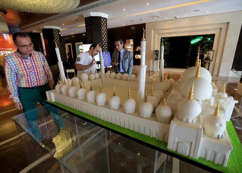 Guests look and walk past a chocolate replica of Shaikh Zayed Grand Mosque made of 130 kilograms of white chocolate. The model was 2 metres long, 1.22 metres wide and 90 centimetres tall. Ravindranath K / The National