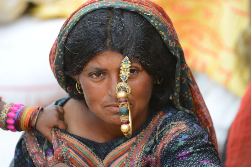 An Indian woman of a shepherd community sits in a camp after migrating from their the drought-stricken Kutch's Banni region of India's western Gujarat state.  AFP