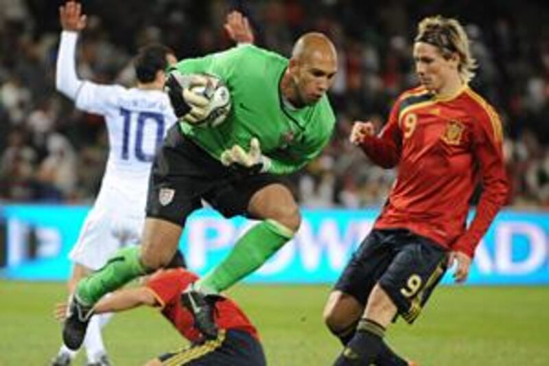 The USA goalkeeper Tim Howard hangs on to the ball as the Spanish striker Fernando Torres challenges during the Confederations Cup semi-final in Bloemfontein.