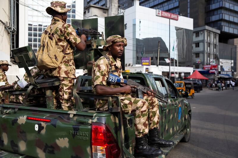 Nigerian soldiers are stationed near a market in Lagos to prevent election-related violence. Reuters