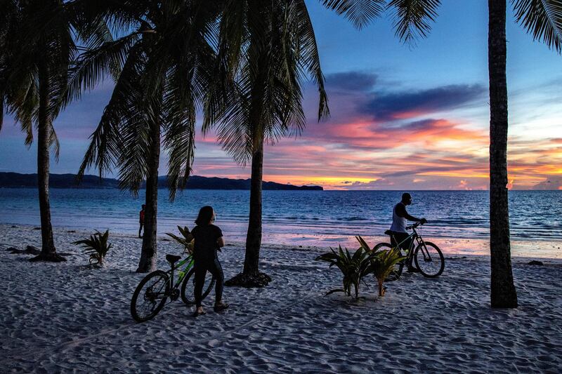 Boracay Island, PHILIPPINES - SEPTEMBER 30: Visitors flock to a beach on September 30, 2020 in Boracay Island, Philippines. The Philippines is reopening Boracay Island, a popular tourist destination known for its resorts and beaches, to more visitors starting October 1 in a bid to revive its pandemic-hit tourism sector. Tourism accounted for almost 13% of the Philippines economic output last year, according to the Department of Tourism. The reopening of Boracay comes as the nation tries to stimulate the economy even as coronavirus cases continue to rise. The country surpassed 312,000 cases of COVID-19, with at least 5,504 deaths. (Photo by Ezra Acayan/Getty Images)