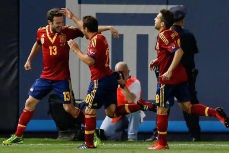 Spain’s Juan Mata, left, is congratulated by teammates after scoring in a 2-0 win over Ireland at Yankee Stadium in New York on Tuesday. Adrees Latif / Reuters