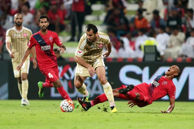 Al Shaab’s Shavkatjon Mulladjanov (35) and Al Ahli’s Ciel (99) collide during their Arabian Gulf League match, the final one of the season, at Rashid Stadium in Dubai on May 8, 2016. Christopher Pike / The National