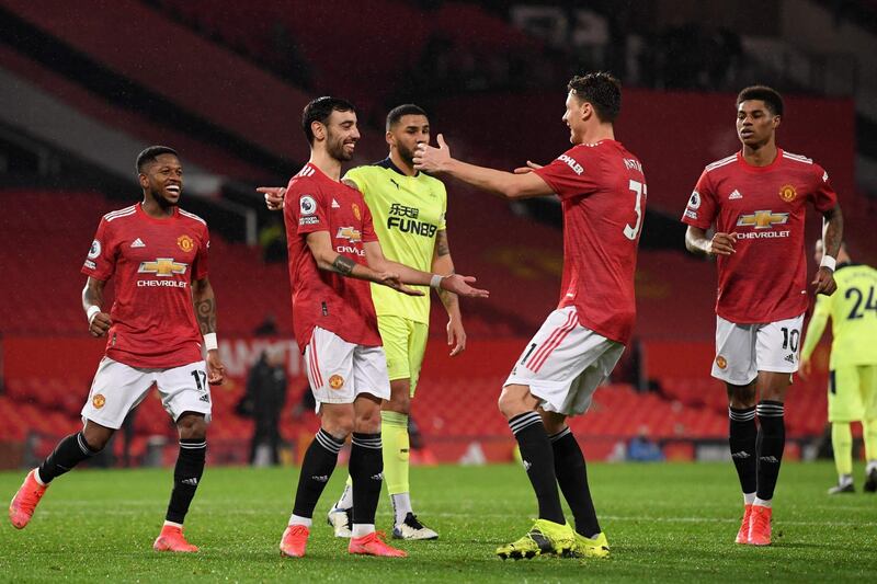Manchester United's Portuguese midfielder Bruno Fernandes (2nd L) celebrates scoring his team's third goal from the penalty spot during the English Premier League football match between Manchester United and Newcastle at Old Trafford in Manchester, north west England, on February 21, 2021. RESTRICTED TO EDITORIAL USE. No use with unauthorized audio, video, data, fixture lists, club/league logos or 'live' services. Online in-match use limited to 120 images. An additional 40 images may be used in extra time. No video emulation. Social media in-match use limited to 120 images. An additional 40 images may be used in extra time. No use in betting publications, games or single club/league/player publications.
 / AFP / POOL / Stu Forster / RESTRICTED TO EDITORIAL USE. No use with unauthorized audio, video, data, fixture lists, club/league logos or 'live' services. Online in-match use limited to 120 images. An additional 40 images may be used in extra time. No video emulation. Social media in-match use limited to 120 images. An additional 40 images may be used in extra time. No use in betting publications, games or single club/league/player publications.
